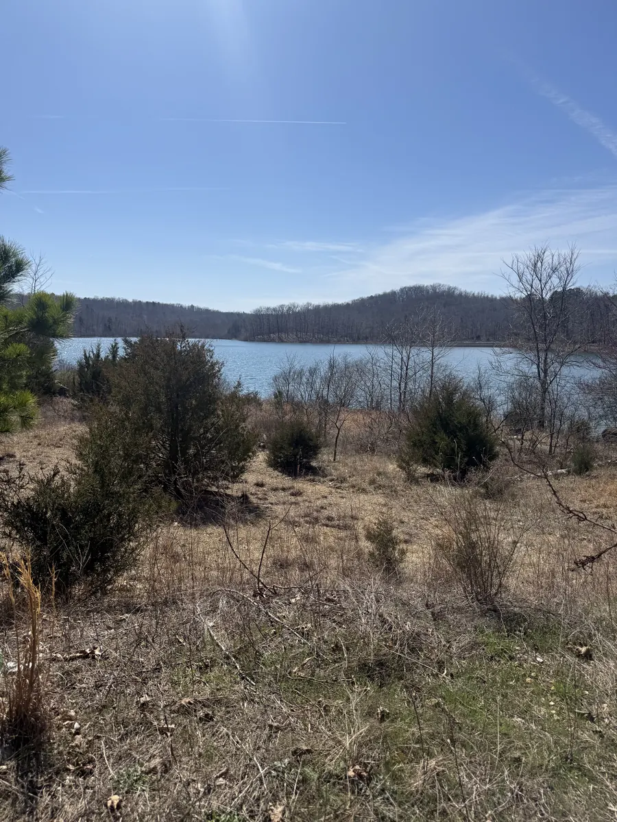 Reservoir lake viewed through early spring landscape — land held in sacred trust