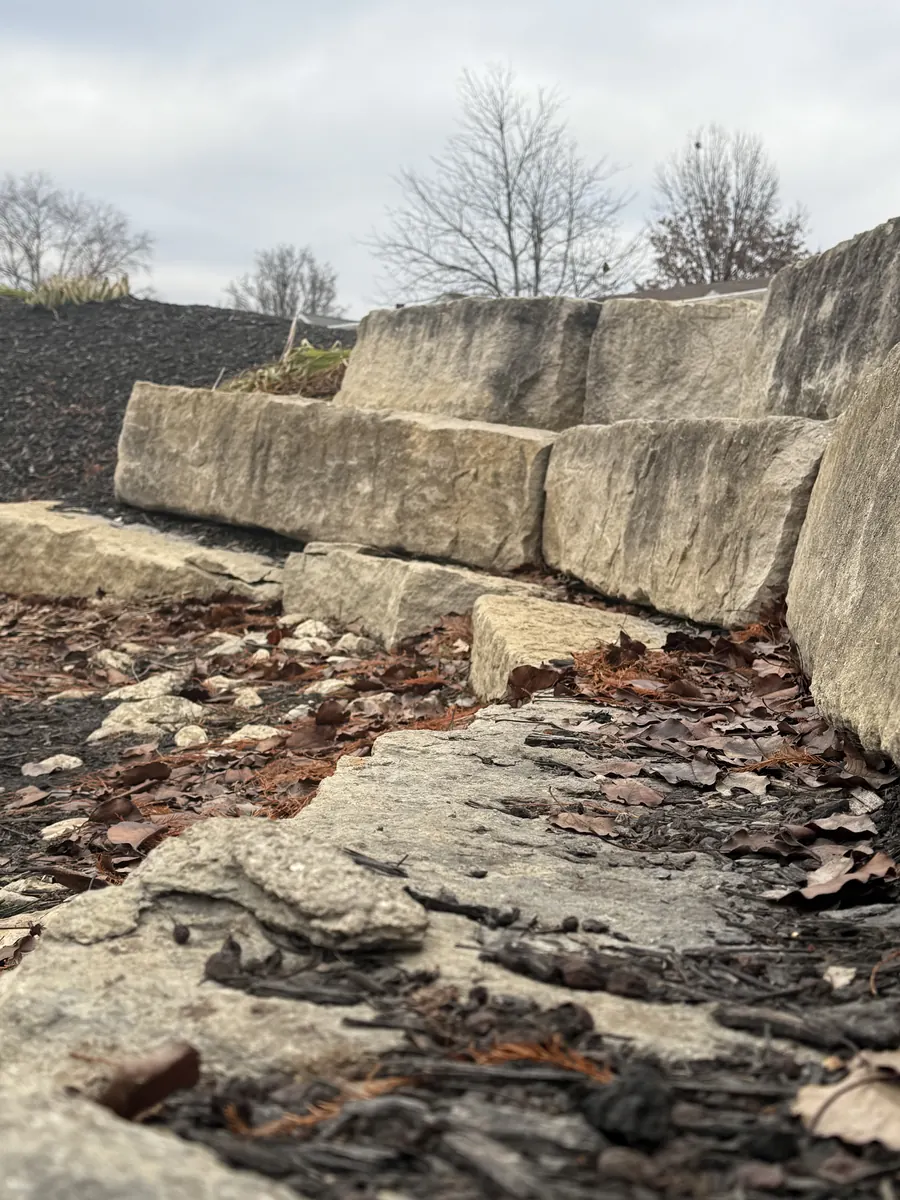 Hand-laid stone retaining wall on chapter land — a testament to sacred stewardship